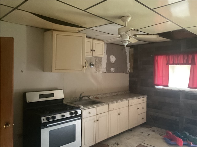 kitchen featuring white electric stove, white cabinets, light tile flooring, sink, and ceiling fan