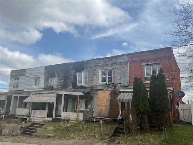 back of property with covered porch