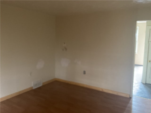 spare room with hardwood / wood-style flooring