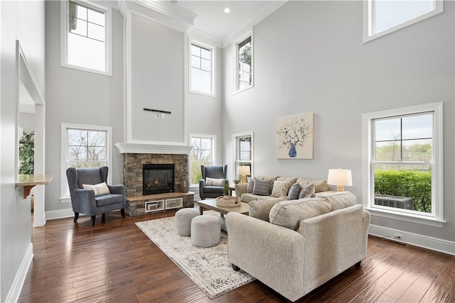 living room with dark hardwood / wood-style flooring, plenty of natural light, and a fireplace