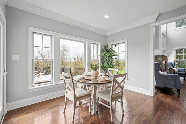 dining space with ornamental molding, a healthy amount of sunlight, and dark hardwood / wood-style floors