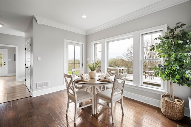 dining area featuring crown molding and dark wood-type flooring