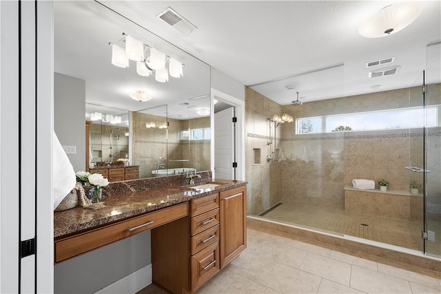 bathroom with an enclosed shower, oversized vanity, and tile floors