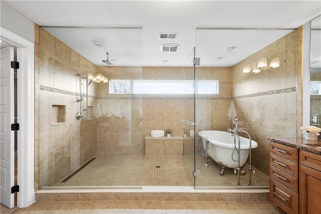 bathroom featuring tile flooring, tile walls, and plus walk in shower