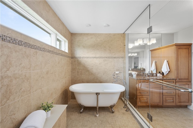 bathroom with tile walls, vanity, a bath, and tile flooring