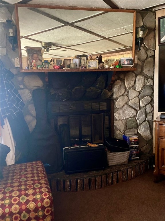 room details featuring a fireplace and dark colored carpet