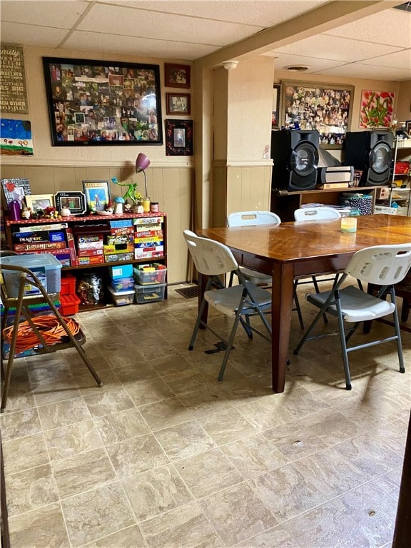 tiled dining room featuring a paneled ceiling