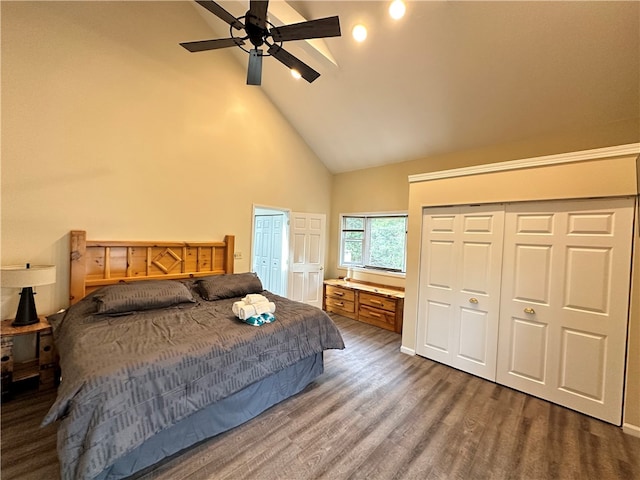 bedroom featuring high vaulted ceiling, ceiling fan, multiple closets, and dark wood-type flooring