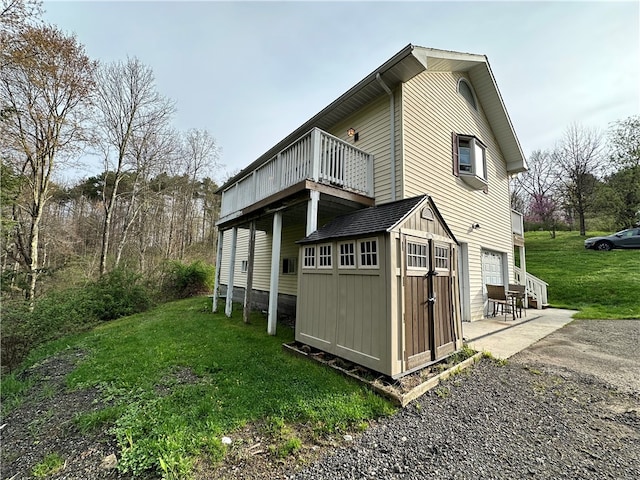 view of home's exterior featuring a patio area, a yard, and a storage shed