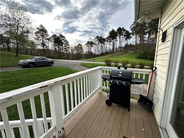 deck featuring grilling area and a yard