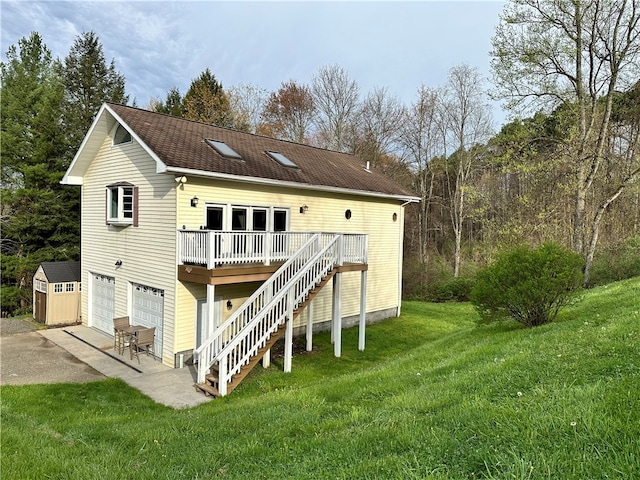 back of property featuring a deck, a storage unit, and a lawn