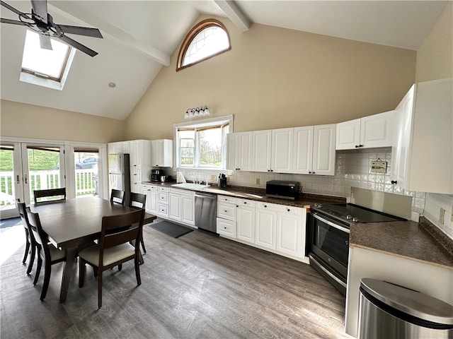 kitchen featuring beamed ceiling, stainless steel appliances, dark hardwood / wood-style flooring, and backsplash