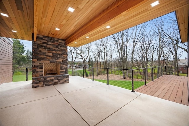 view of patio featuring an outdoor stone fireplace