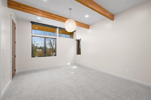 unfurnished room with beamed ceiling and carpet