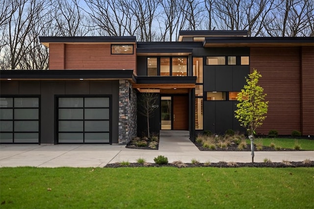 modern home with a garage and a front lawn