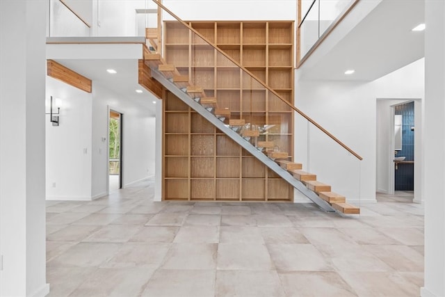 staircase featuring light tile patterned floors