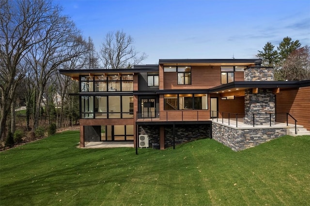 rear view of house with a patio and a lawn