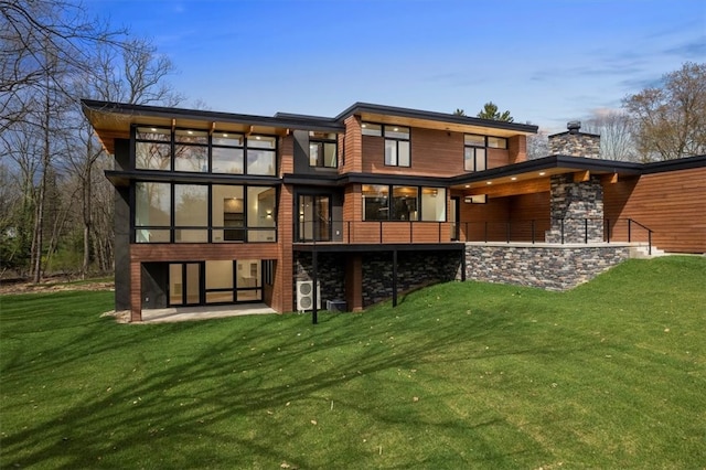 back of house featuring a patio area and a lawn