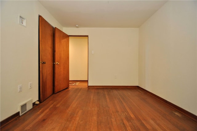 empty room featuring dark wood-type flooring