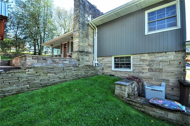 exterior space featuring a yard and central AC