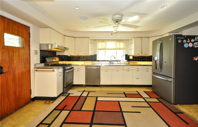 kitchen featuring backsplash, ceiling fan, stainless steel appliances, light tile flooring, and white cabinets