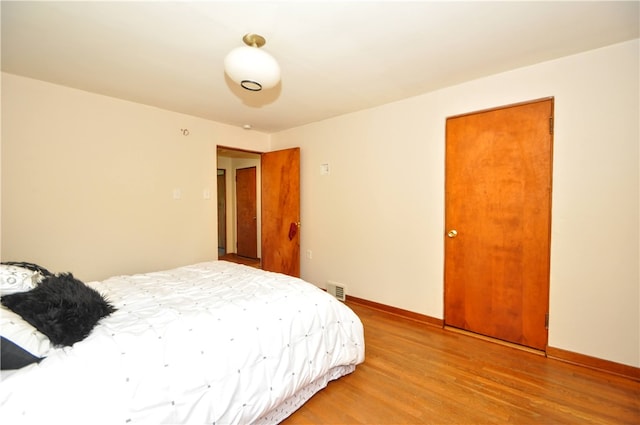 bedroom with a closet and light hardwood / wood-style floors