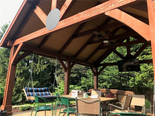 view of patio / terrace featuring ceiling fan, an outdoor living space, and a gazebo