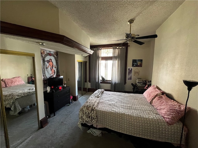 bedroom featuring a closet, a textured ceiling, dark carpet, and ceiling fan