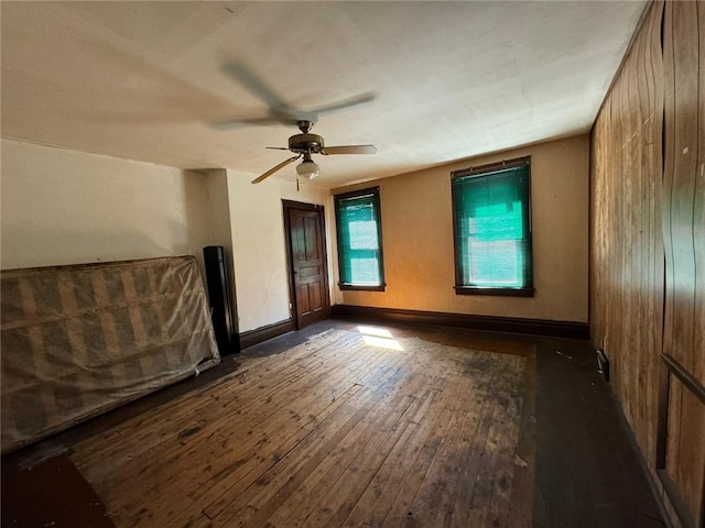 spare room with ceiling fan and dark hardwood / wood-style flooring