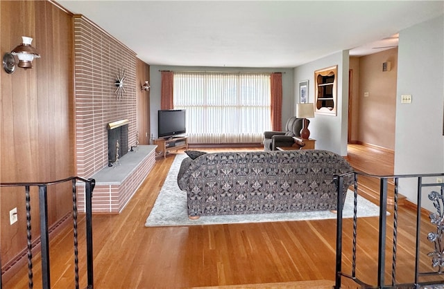 living room with light hardwood / wood-style floors and a fireplace