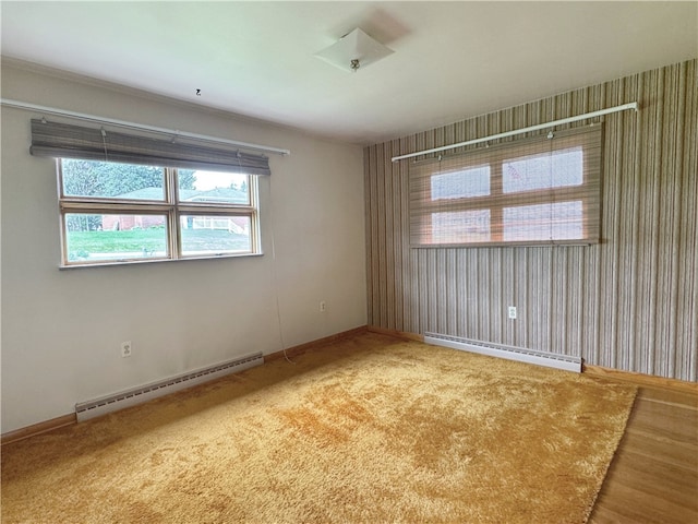 spare room with light hardwood / wood-style flooring and a baseboard heating unit