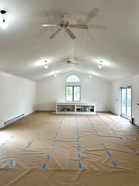 empty room featuring baseboard heating and vaulted ceiling