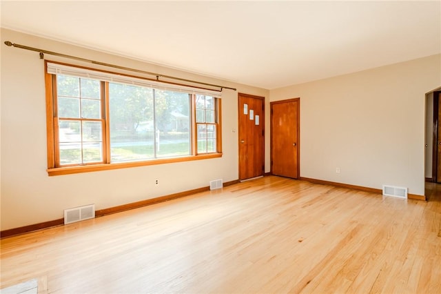 spare room with plenty of natural light and light wood-type flooring