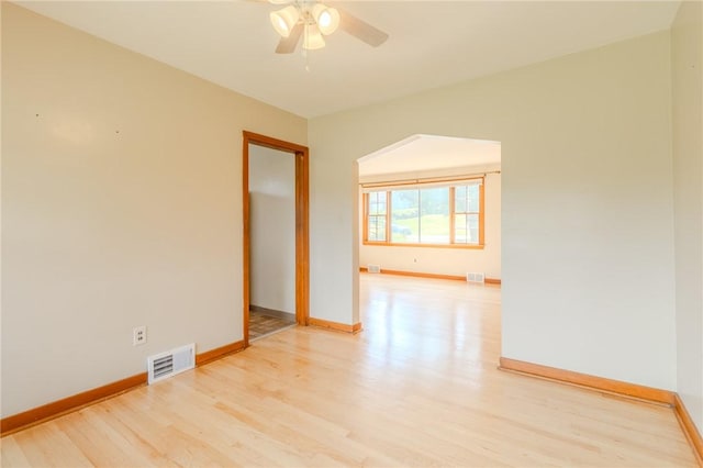 empty room featuring ceiling fan and light wood-type flooring