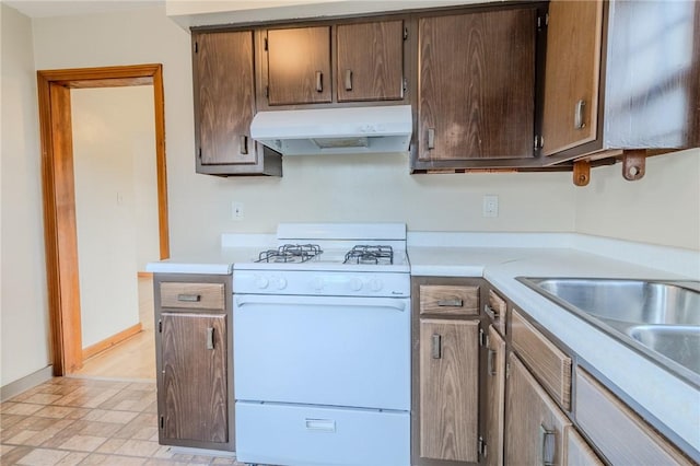 kitchen featuring white gas stove and sink