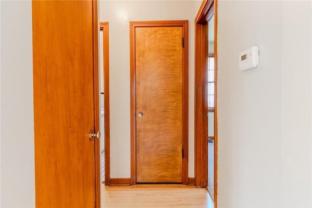 corridor with light wood-type flooring