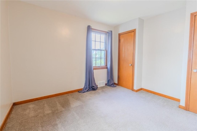 empty room featuring light carpet