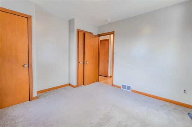 unfurnished bedroom featuring light colored carpet