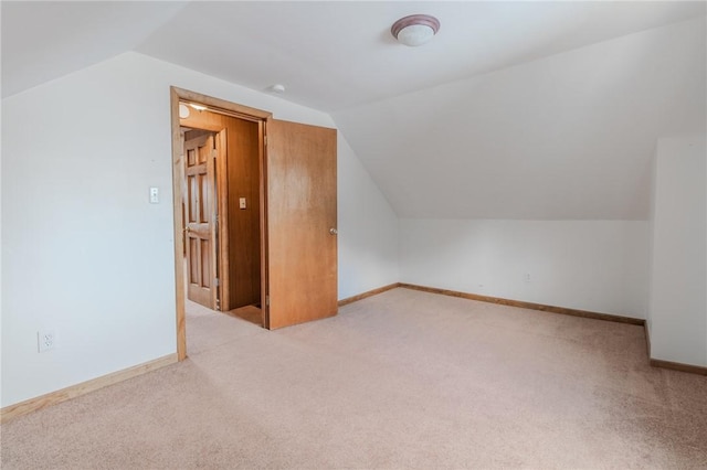 bonus room with light carpet and lofted ceiling