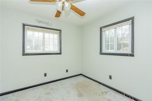 empty room with a healthy amount of sunlight, ceiling fan, and carpet