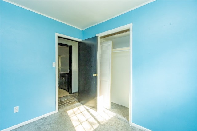 unfurnished bedroom with carpet and a closet