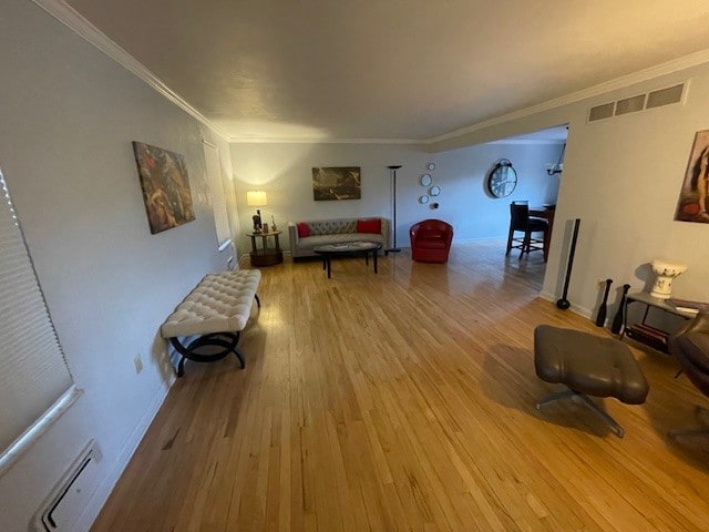 living room featuring ornamental molding and hardwood / wood-style floors