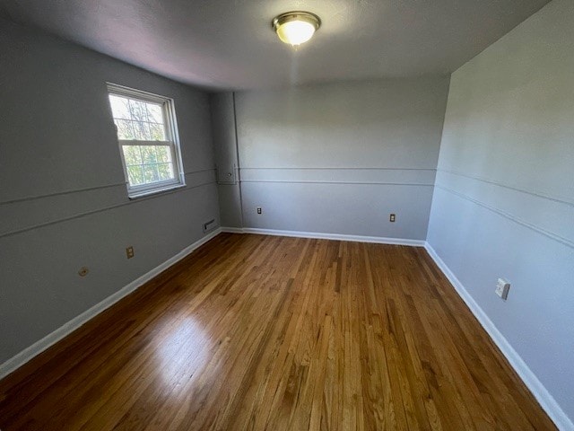 spare room with hardwood / wood-style floors