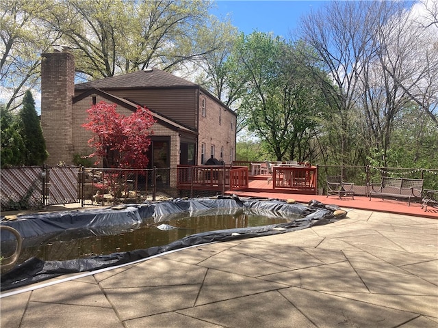 view of swimming pool with a wooden deck