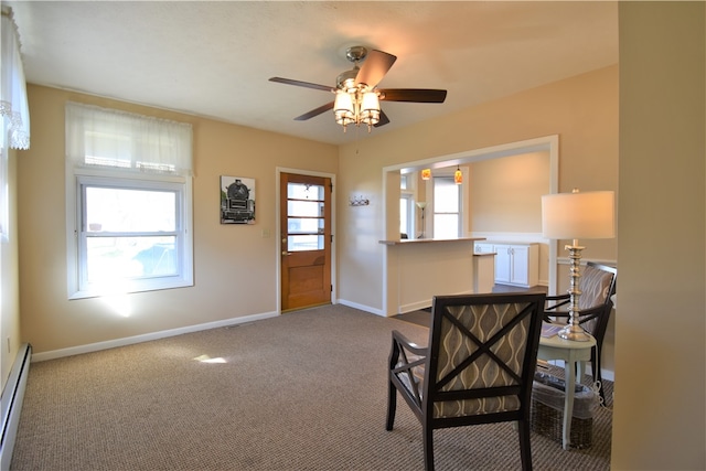 interior space with a healthy amount of sunlight, a baseboard heating unit, carpet flooring, and ceiling fan