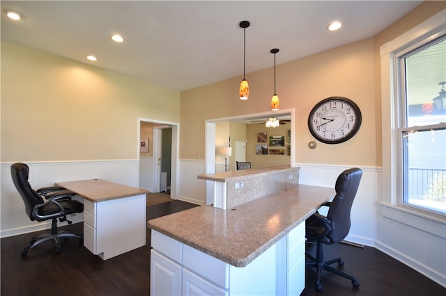 office with ceiling fan and dark wood-type flooring