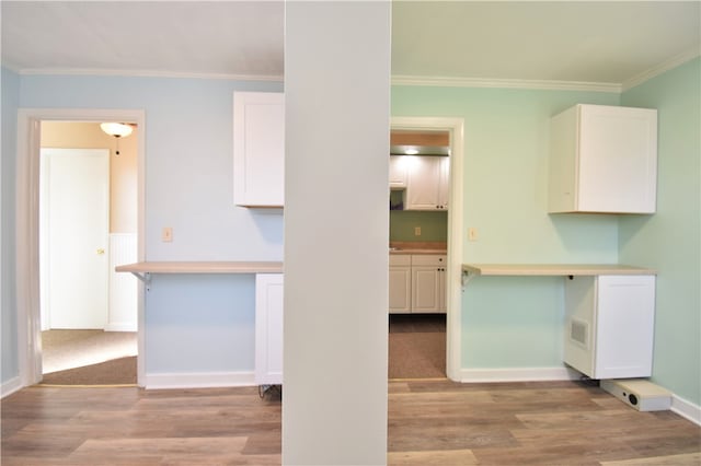 kitchen featuring hardwood / wood-style flooring and white cabinets