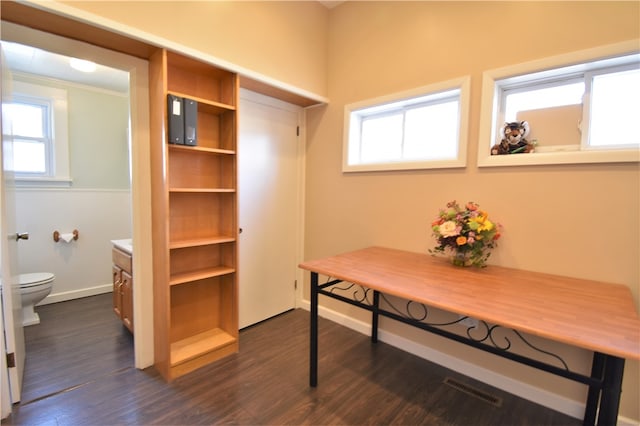 office space with dark hardwood / wood-style flooring and crown molding