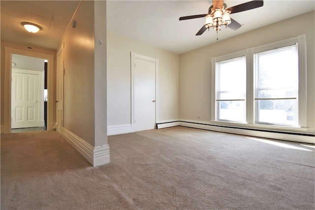 carpeted empty room with baseboard heating and ceiling fan