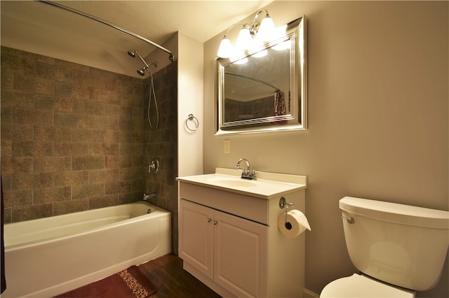 full bathroom with tiled shower / bath combo, wood-type flooring, vanity, and toilet